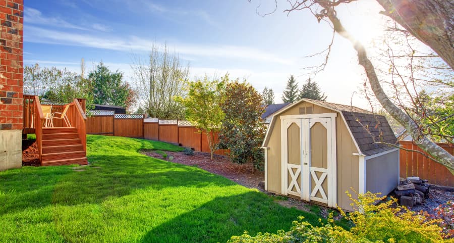 Fenced backyard with storage shed in Medford